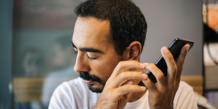 Person listening to iPhone.